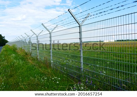 Security fence of an international airport in Hanover HAJ, Lower Saxony, Germany.