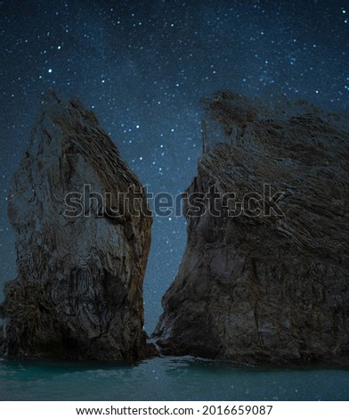 rock by night with stars at beach