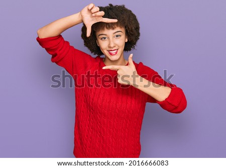 Young hispanic girl wearing casual clothes smiling making frame with hands and fingers with happy face. creativity and photography concept. 