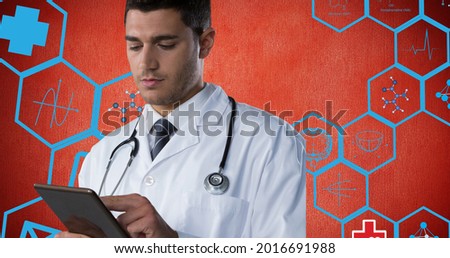 Composition of male doctor using tablet over digital icons on red background. flu, sickness, virus and vaccination concept digitally generated image.