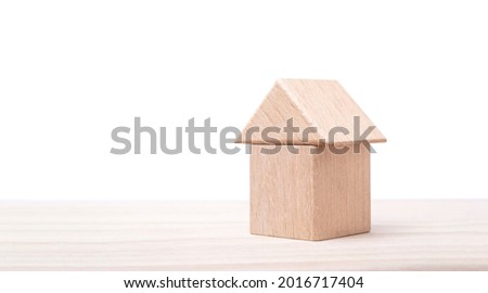 a wooden house on table for decoration. 