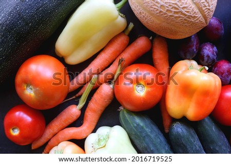 Various colorful summer fruit and vegetable on dark background. Flat lay.