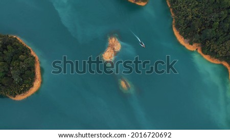 bird flight. top view. Coastal And Oceanic Landforms. Water Resources. Watercourse. Geological Phenomenon. Nature Reserve. Island. Rocks off the coast of the ocean.. Water Resources. Watercourse. Guad