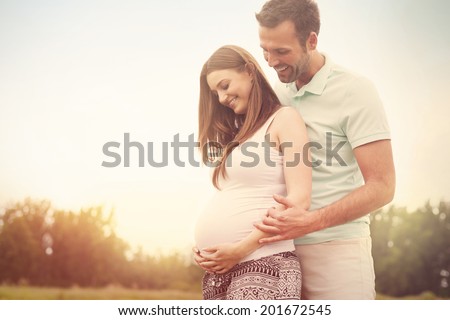 Portrait of lovely future parents during sunset   Royalty-Free Stock Photo #201672545