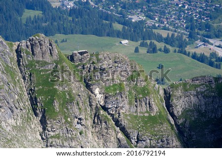 Panoramic view of ridge at mountain Brienzer Rothorn at Bernese Highlands with village of Sörenberg in the background on a beautiful sunny summer day. Photo taken July 21st, Flühli, Switzerland.