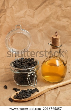 sunflower oil with a bag of seeds and a wooden spoon