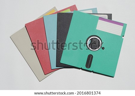 5.25-inch floppy disks were popular in the 80's and 90's as data storage area. Colorful floppy disk on white background.  Royalty-Free Stock Photo #2016801374