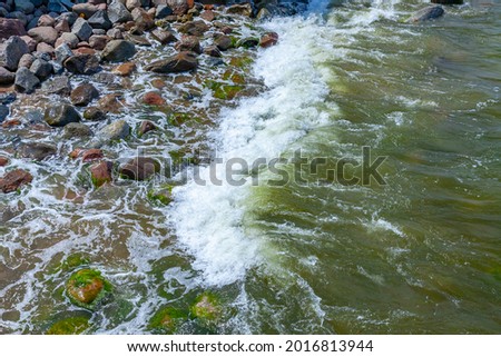 Sea wave and wet stones, natural background
