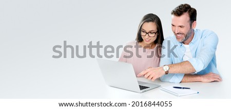 Smiling couple sitting at the computer. Financial concept, beautiful white smile. Banner with copy space