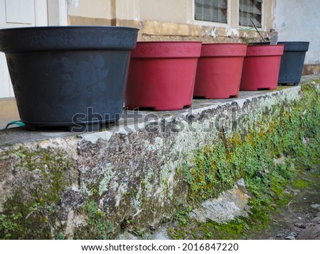 A row of red and black buckets