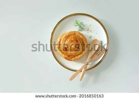 Layered grape cake, traditional French croissant breakfast isolated on white background. Pain aux raisin top angle view