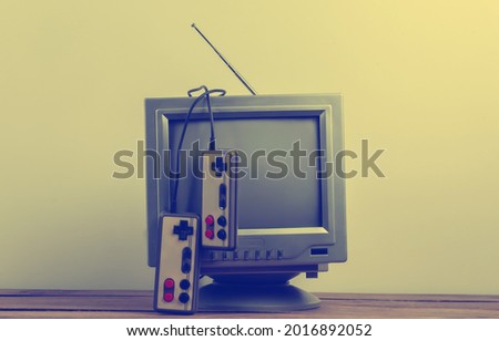 Retrogaming. Video game competition. Old TV with gamepads on white background. Attributes 80s