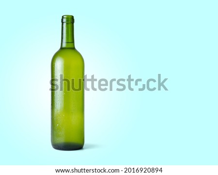 Bottle of fresh white wine isolated from the blue background with copy space