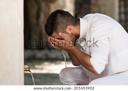 Islamic Religious Rite Ceremony Of Ablution Face Washing Royalty-Free Stock Photo #201693902
