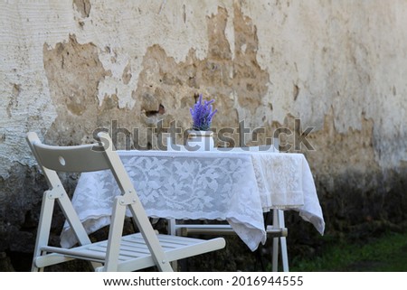 Terrace of a cafe near a castle wall. High quality photo. Selective focus Royalty-Free Stock Photo #2016944555