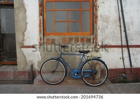 A bicycle with a basket leaning against a stone wall in the old town of Galle fort, Galle, Sri Lanka. Royalty-Free Stock Photo #201694736