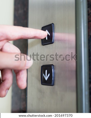 Close up of man pressing elevator button.