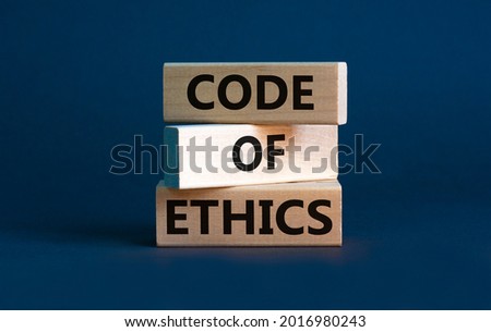 Code of ethics symbol. Concept words 'Code of ethics' on wooden blocks on a beautiful grey background. Business and code of ethics concept. Copy space.