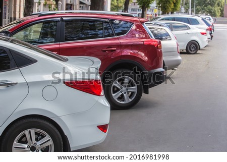 Cars are parked on a city street in the city center