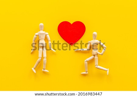 Man and woman connection. Couple of wooden mannequin figures with heart