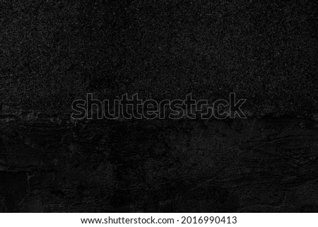 The concrete walls are painted black with stains texture and background seamless