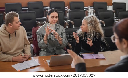 The teacher and students communicate in sign language in the classroom. Hearing impaired and deaf people Royalty-Free Stock Photo #2017059029