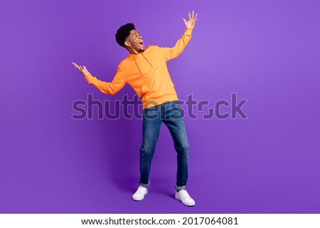Full body photo of positive young dark skin man look empty space hands amazed isolated on violet color background Royalty-Free Stock Photo #2017064081