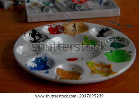 Bandar Lampung, Indonesia - February 29, 2020 : painting equipment at the painting course, there are paints, brushes, paint plates with various colors on them, after use.