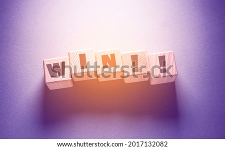 Win Word Written on Wooden Cubes