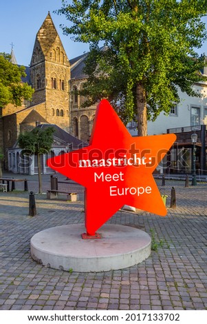 Red star icon with text in front of the church tower in Maastricht, Netherlands