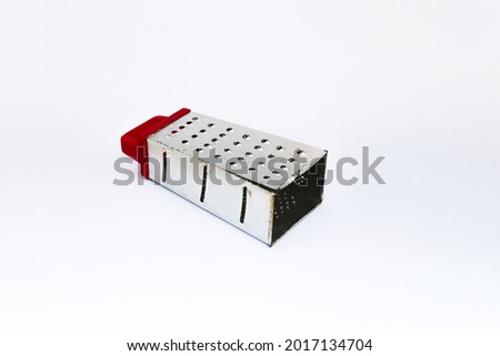 Grater with red handle isolated on white background. Kitchen utensil background stock images.