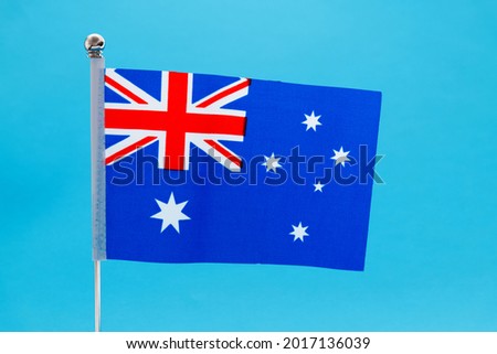 Australian national flag waving on blue background.
