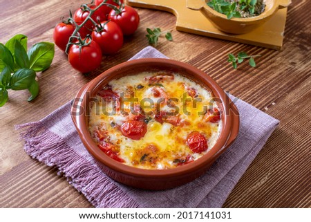 baked cheese and tomatoes in bowl 