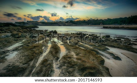 Beautiful beach panorama landscape view. Great wallpaper picture format 16x9 with rock layer foreground