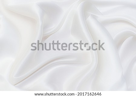 Background abstract texture of natural light color fabric. Fabric texture of natural cotton or linen, silk or satin, wool or jersey textile material. Luxurious white canvas background. Royalty-Free Stock Photo #2017162646