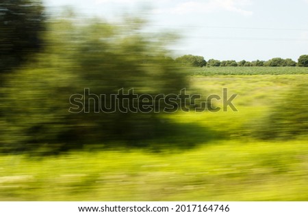 view from the window of a fast moving train on summer day