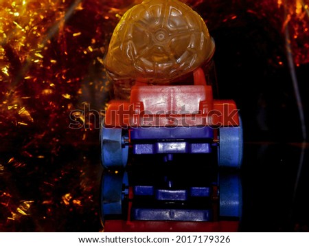 Toy car burning on fire background, automobile toy accident concept presented with fire light effect.