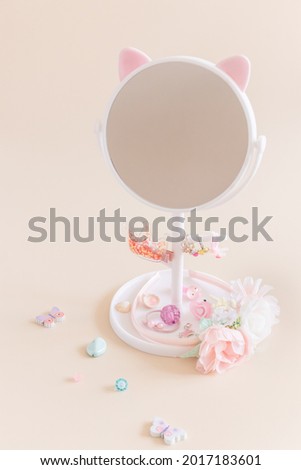 Round mirror on a leg with a stand for storing girly jewelry