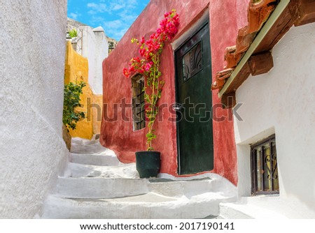 Street in Anafiotika, Plaka district, Athens, Greece. Plaka is famous tourist attraction of Athens. Cozy alley, vintage houses at Acropolis slope in old Athens town. Theme of places, travel in Athens