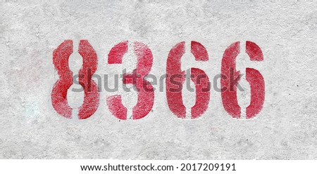 Red Number 8366 on the white wall. Spray paint. Number eight thousand three hundred and sixty six.
