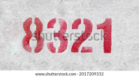 Red Number 8321 on the white wall. Spray paint. Number eight thousand three hundred and twenty one.