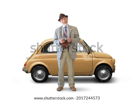Old man in a suit smiles and holds a camera in his hands