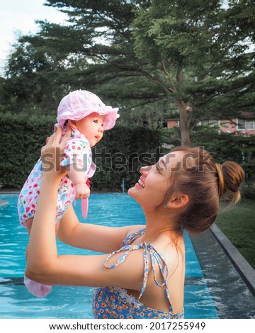 A nice girl and Asian mother enjoy sunny morning. Good time family.