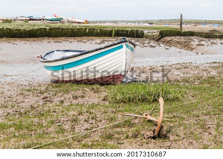 Boat anchored to the shore at Brancaster Staithe on the North Norfolk coast pictured in June 2021.