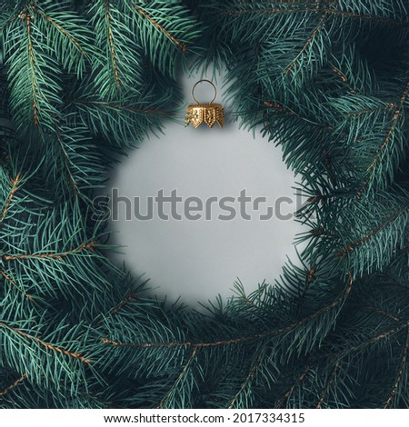 Silhouette of a Christmas ball made of pine branches. Creative Christmas layout. 