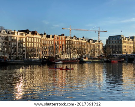 Two kayakers on the Amstel river in Amsterdam, the Netherlands.