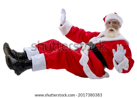 Santa Claus sitting on the floor on white background isolated. Senior male actor old man with a real white beard in the role of Father Christmas