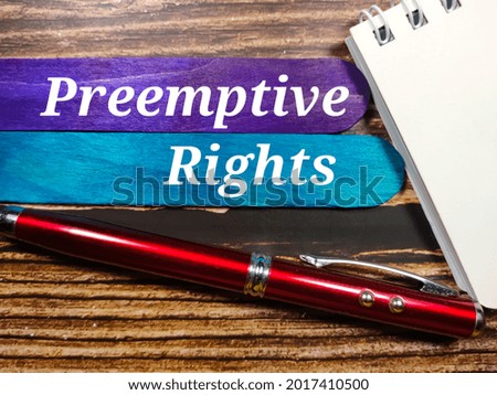Business concept.Text Preempitve Rights writing on colored ice cream sticks with pen,notebook on wooden background.
