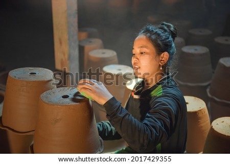 Potter's wheel and the hands of an artisan movement. portrait of woman potter making pot in pottery workshop factory