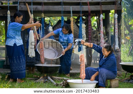Crafts and craftsmanship. Traditional Isan Thai silk indigo weaving.Craftsmen of Thai Silk. selective focus Royalty-Free Stock Photo #2017433483